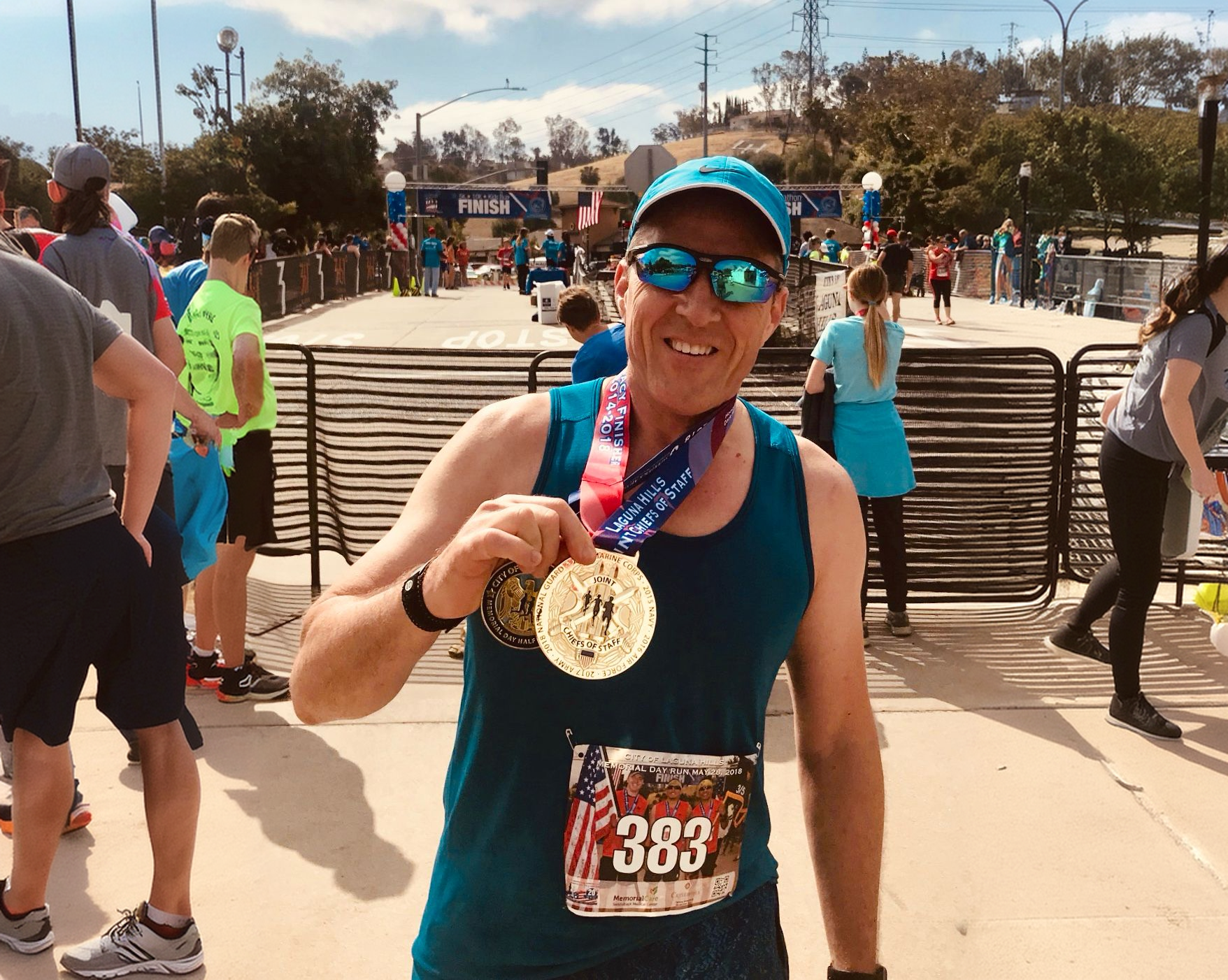 Danny holding a marathon medal